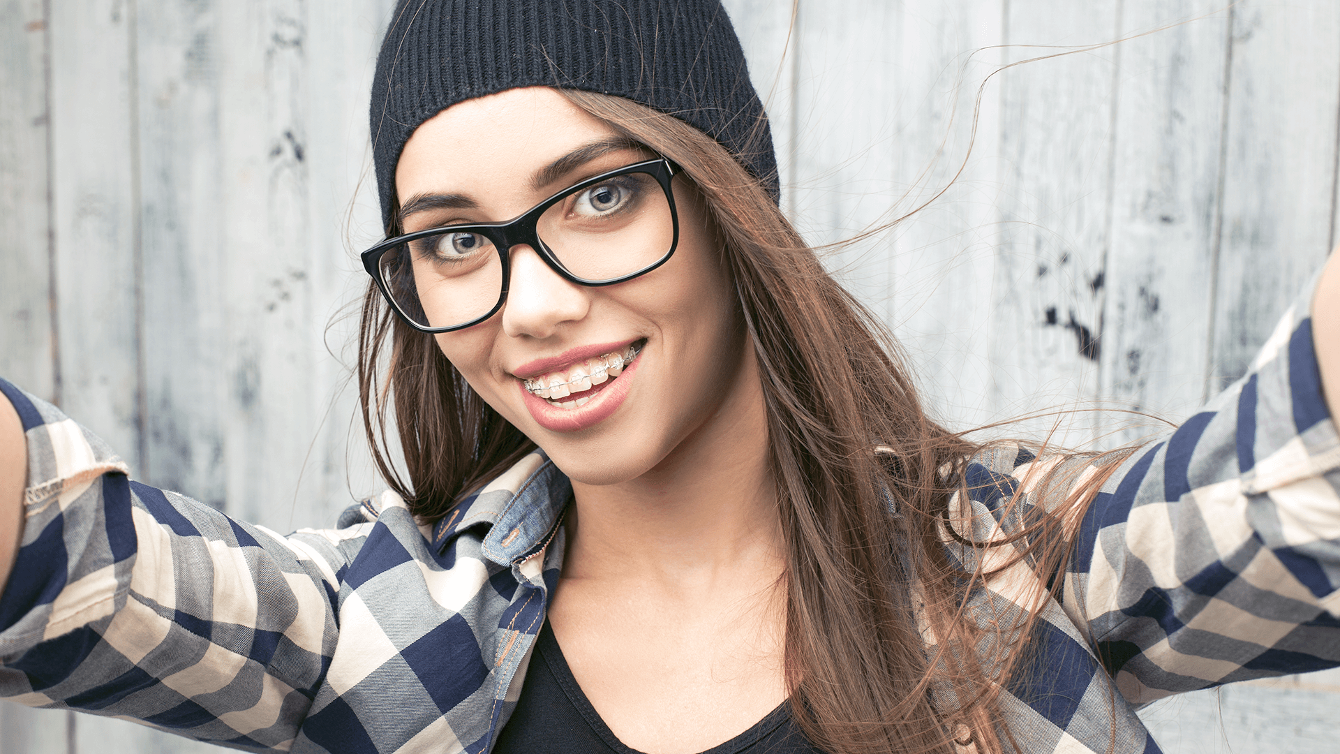 Women with braces smiling